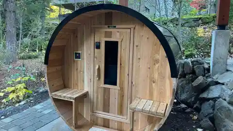 Nootka barrel sauna with electrical control panel in forest setting