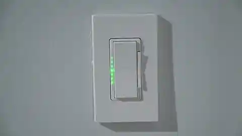 White rocker-style dimmer switch installed on wall
