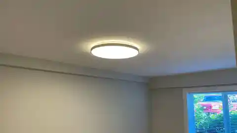 Modern LED flush mount ceiling light with warm glow in bedroom