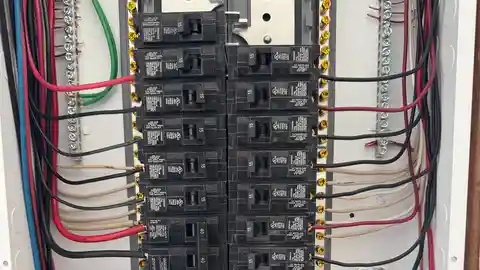Interior of residential electrical panel with organized breakers and wiring
