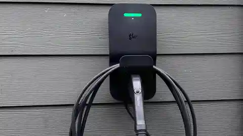 FLO electric vehicle charger with green indicator light in residential garage