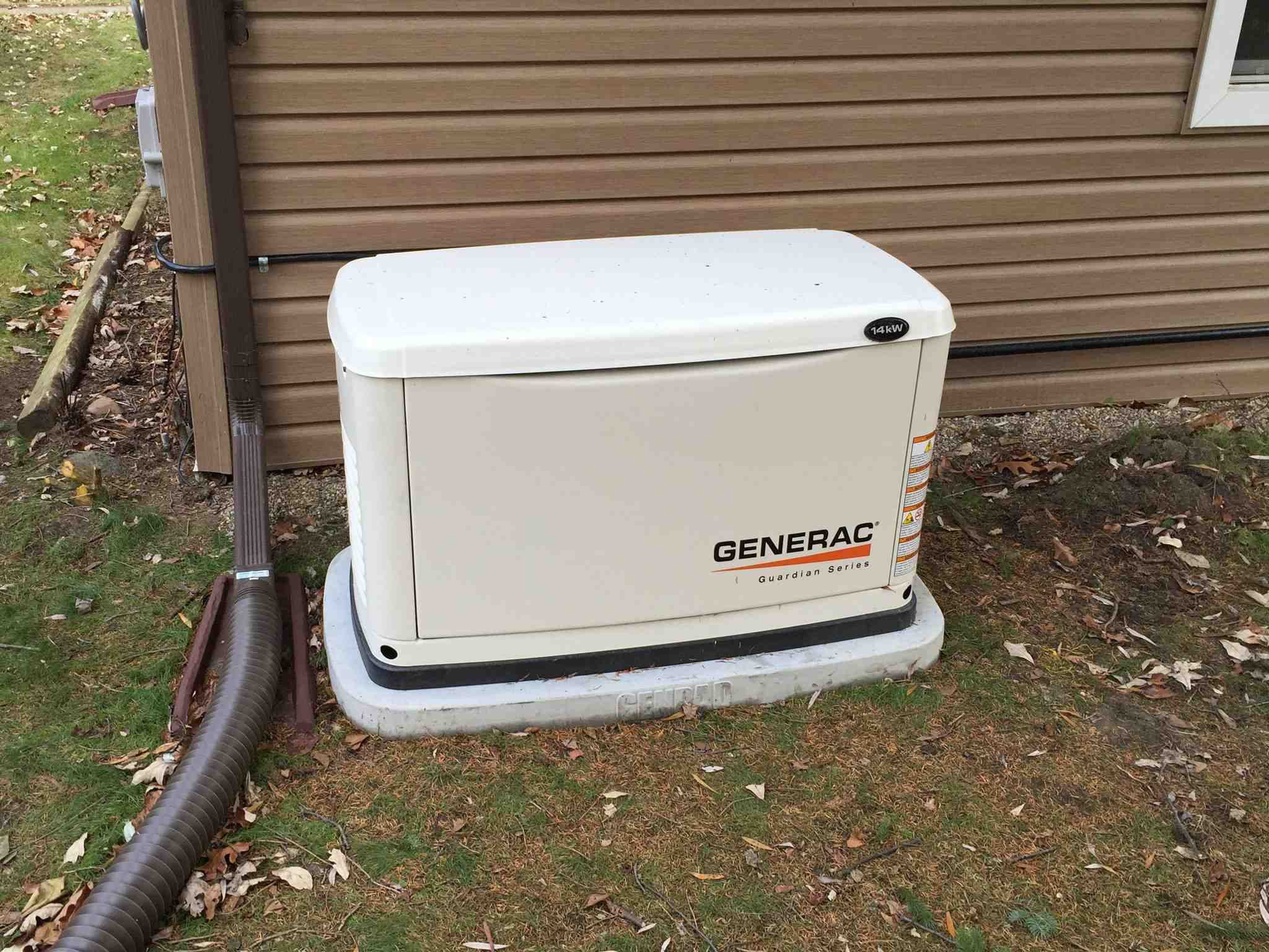 White Generac backup generator installed on gravel pad at Whistler home