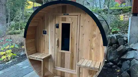 Nootka barrel sauna with external control panel in forest setting