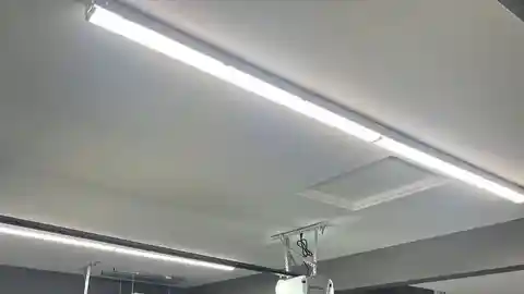 LED strip lights on white garage ceiling with door opener