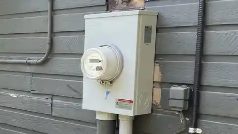Eaton 200-amp meter base and panel combo on gray siding exterior