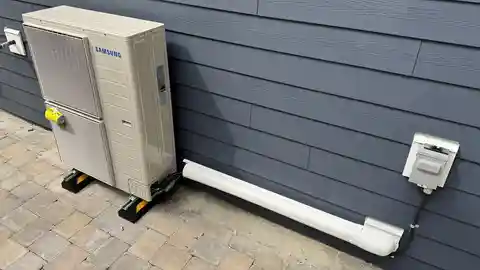 Samsung heat pump on stand with line set cover and electrical disconnect