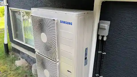 Samsung WindFree heat pump mounted on exterior wall with garden landscaping