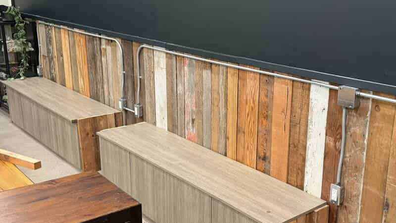 Surface-mounted conduit and outlets on reclaimed wood wall